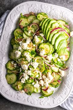 cucumber and feta salad on a white platter