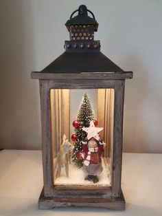 a lantern with a christmas scene inside it