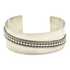 This is part of Chairish’s Costume Jewelry assortment.  Stunning 1" wide sterling silver cuff bracelet was made by well-known Navajo silversmith, Tom Hawk. It has a simple clean diagonal design with two ropes on either side of a beaded line.  Marked Tom Hawk Sterling.  Interior of the cuff measures 5 3/4" with an additional 1 1/4 " gap for a total circumference of 7". This cuff is adjustable.  Width measures 2.73" straight across the widest part (from wrist bone to wrist bone). Bracelet face measures 1" tall (the face of the bracelet, north to south). Bracelet depth from top to the underside of wrist is 1.90". Chanel Cuff Bracelet, Blue Cuff Bracelet, Chanel Cuff, Black Cuff Bracelet, Rustic Cuff Bracelets, Diagonal Design, Bone Bracelet, Bones Bracelet, Crystal Cuff Bracelet