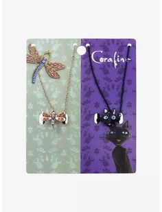 two necklaces with cats and dragon pendants attached to them on a purple background