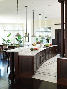 a large kitchen with an island in the middle and lots of counter space on each side