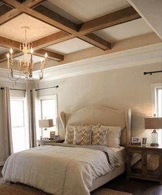 a bedroom with a large bed and chandelier