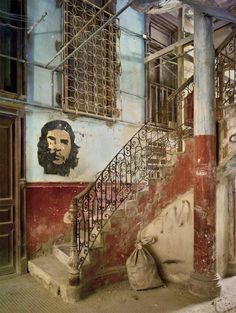 an old building with stairs and graffiti on the walls