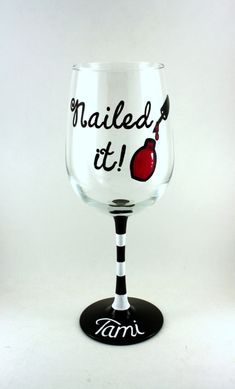 a wine glass with the words nailed it written in black and red ink on top