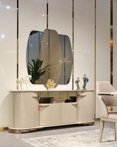 a white table with a mirror on it in front of a chair and vases