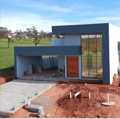 the house is being built in the middle of the dirt field and ready to be used as a home