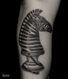 a black and white tattoo of a zebra's head with a chess piece on it