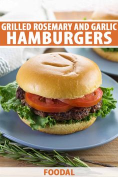 grilled rosemary and garlic hamburgers on a blue plate with text overlay that reads grilled rosemary and garlic hamburgers