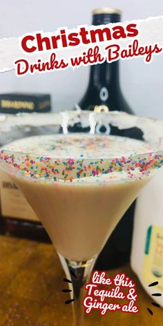 a christmas drink with sprinkles in a martini glass on a counter top