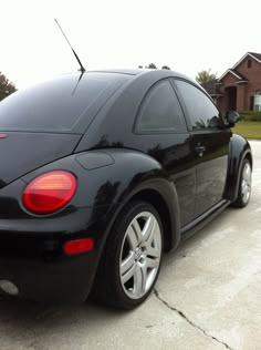 a black car parked in front of a house