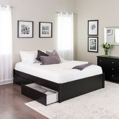 a modern bedroom with white and black furniture