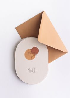 an envelope with a sticker on it next to a piece of paper that says maud