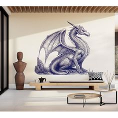 a living room with a couch, coffee table and large wall mural depicting a dragon