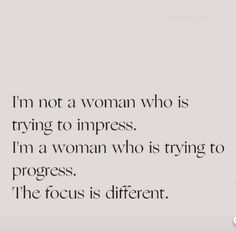 a woman is standing in front of a white wall with the words i'm not a woman who is trying to impress