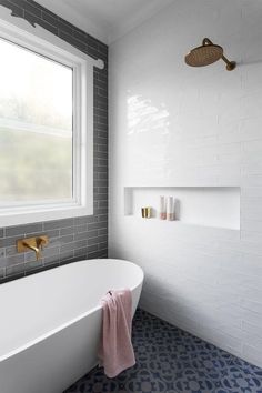 a white bath tub sitting next to a window