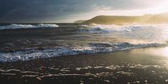 the sun shines brightly on an ocean beach