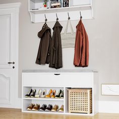 the shoes are lined up on the shelf next to the coat rack in the entryway