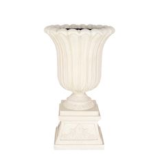 a white vase sitting on top of a table