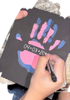 a person is drawing on a piece of paper that has been placed in front of them