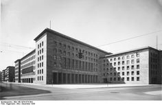 an old black and white photo of two buildings