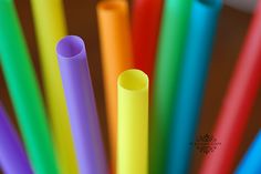 several different colored straws in a cup