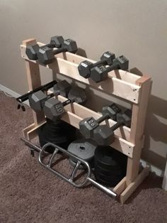 a gym equipment rack with dumbs on it