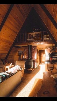 an attic bedroom with wood paneling and exposed ceiling