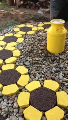 yellow and black stones are arranged in the shape of hexagons