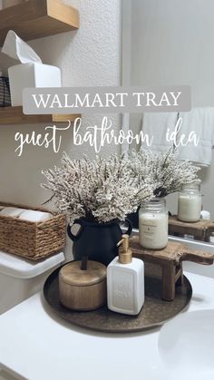 a bathroom sink with candles, soap and flowers on it that says walmart tray guest bathroom idea