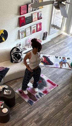 a woman standing on top of a rug in a living room