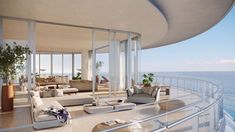 a balcony overlooking the ocean with couches and chairs