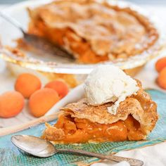 a piece of pie with ice cream on top and some oranges in the background