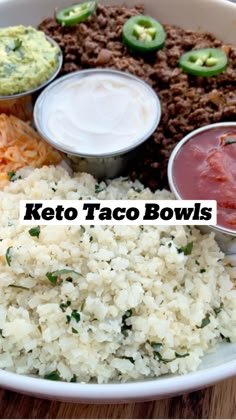 a white bowl filled with rice and sauces next to other foods on a wooden table