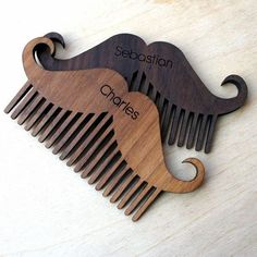 two wooden combs with the words sebastian and charles engraved on them, sitting next to each other