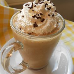 a cup with whipped cream and chocolate sprinkles