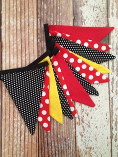 three red and black polka dot buntings with white dots on them sitting on a wooden