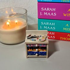 a candle and some books on a table