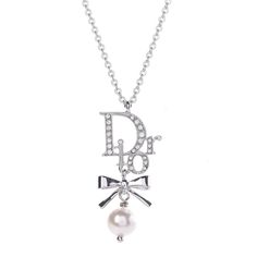 Christian Dior Crystal Pearl Dior Logo Necklace Silver- Excellent Condition. The exquisite detail and charm of this Christian Dior necklace make this an ideal piece for your collection. The necklace features a faux resin pearl suspended from a Swarovski crystal-encrusted silver Dior logo. This Christian Dior® item has been authenticated by our in-house trained professionals.Dior is a registered trademark of Christian Dior® Caroline's Fashion Luxuries is not affiliated with Christian Dior® Christian Dior Necklace, Resin Pearl, Dior Necklace, Logo Necklace, Dior Logo, Jewelry Accessories Ideas, Jewelry Lookbook, Dream Jewelry, Jewelry Inspo