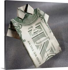 an origami house made out of one dollar bill on a gray background canvas print