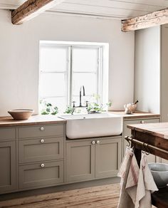 a white sink sitting under a window in a kitchen