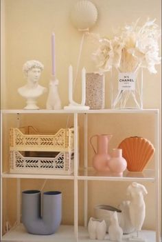 a shelf with vases and other items on it