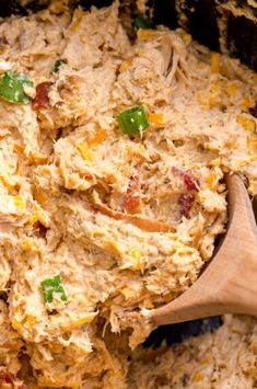 a wooden spoon mixing food in a pot