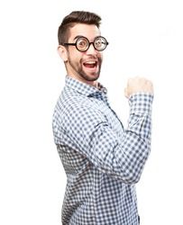 a man with glasses and a checkered shirt is raising his fist in the air