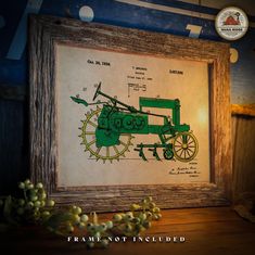 an old framed drawing of a green tractor