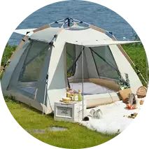 a tent is set up on the grass by the water with food and drinks in it