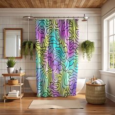 a colorful shower curtain in a bathroom next to a bathtub and window with potted plants