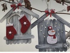 two wooden houses with christmas stockings hanging from them