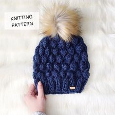 a knitted beanie with a pom - pom on top and the words knitting pattern below it