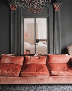 a living room filled with furniture and a chandelier