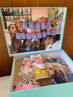 a birthday cake in a box with pictures and candles on it that spell out the number twenty